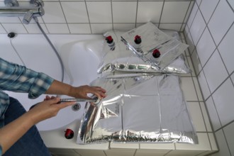 Filling a 10 litre water bag, for storing drinking water at home, as an emergency reserve in the