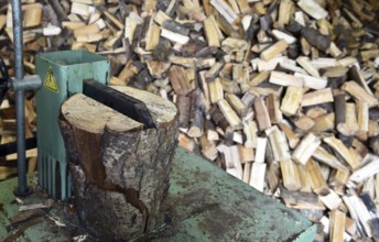 Firewood, splitting with a log splitter, axe