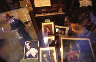 Shop window decoration in honor of Giuseppe Verdi, with pictures of opera Opera singer and