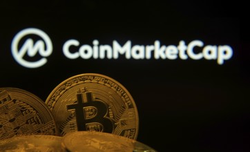 Dhaka, Bangladesh- 27 March 2025: Close-up of Bitcoin coins with the Coinmarketcap logo visible on