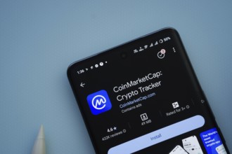 Dhaka, Bangladesh- 29 May 2025: On a blue surface, a smartphone displays the Coinmarketcap app