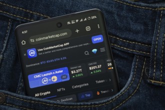 Dhaka, Bangladesh- 15 June 2025: A smartphone displaying the Coinmarketcap.com web interface peeks