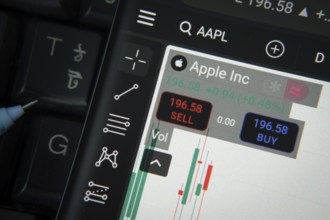 Apple Inc stock trading details on smartphone over a keyboard
