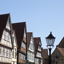 Street with half-timbered houses and historic street lamp in the old town centre, Celle, Lower