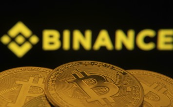 Dhaka, Bangladesh- 22 June 2025: Close-up of Bitcoin coins with the Binance logo visible on a