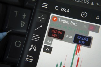 Dhaka, Bangladesh- 20 June 2025: Tesla stock trading details on smartphone over a keyboard