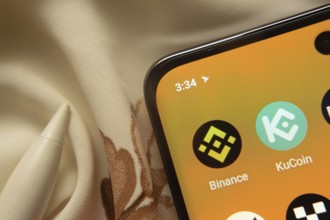 Dhaka, Bangladesh- 07 May 2025: Binance and KuCoin app icon is seen on smartphone