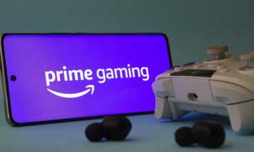 Dhaka, Bangladesh- 22 June 2025: A smartphone with a prime gaming app icon next to a controller and