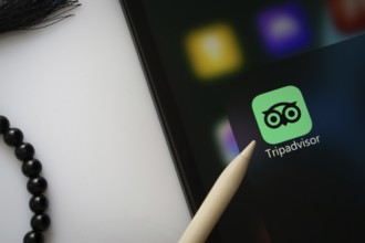 Dhaka, Bangladesh- 22 June 2025: A close up of an iPad screen displaying the Tripadvisor app