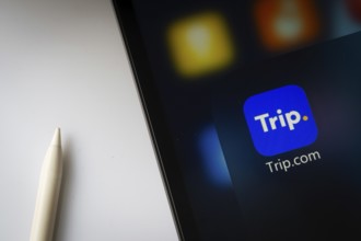 A close up of an iPad screen displaying the trip.com app