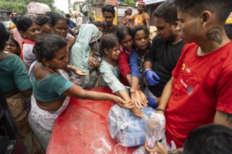 Devotees throng to have food as they arrives to visit Kamakhya Temple during Ambubachi Mela, in