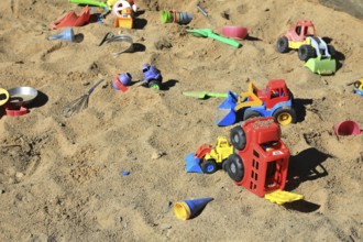Playground, sandpit with plastic toys, vehicles, shovel