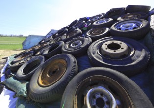 Old wheels, rims and tyres, used here to weigh down the cover of an agricultural silo