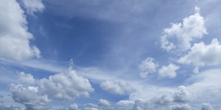 Blue sky with fluffy white clouds creating a serene and peaceful atmosphere