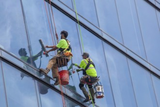 Detroit, Michigan - Window washers at the 25-story Residences Water Square luxury apartment