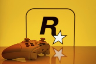 Dhaka, Bangladesh- 17 June 2025: Game controller in front of rockstar games logo on a background