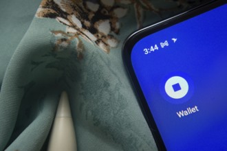 Dhaka, Bangladesh- 07 May 2025: Coinbase Wallet app icon is seen on smartphone