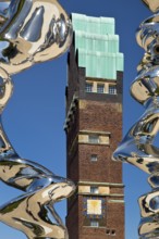 Stainless steel sculpture entitled Points of View by Tony Cragg in front of the Wedding Tower,