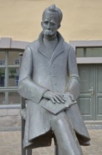 Monument to philosopher Friedrich Nietzsche, bronze sculpture, modern art, standing female figure,