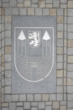 City coat of arms on the ground with paving stones, market square, Weißenfels, Saxony-Anhalt,