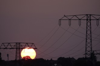 Transmission of energy with high-voltage lines, symbolic image for the energy transition, evening