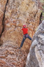 Man rock climbing at The Pit in Sandy's Canyon, Flagstaff, Arizona, USA