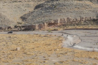 People riding all terrain vehicles through Echo Wash at Echo Bay, Nevada, USA