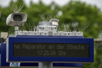 Display board, at a station, train cancellation announcement due to construction work, display