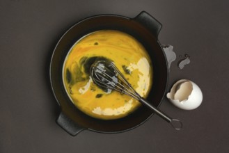 Cracked egg in a pan, hen's egg and eggshells