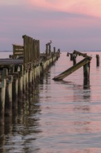 Dilapidated fishing pier damaged from hurricanes in Long Beach, Mississippi, USA