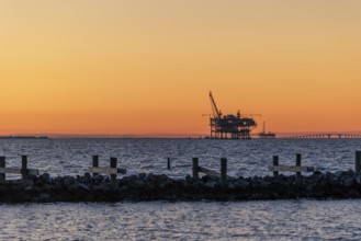 Oil and gas drilling rigs on the Gulf of Mexico horizon at Fort Morgan, Alabama, USA