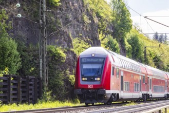 Regional express RE5 en route on the winding railway line of the Geislinger Steige. Landscape along