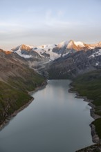 View at the summit of Mont de la Blana, alpenglow at sunset, view of a blue mountain lake, Lac des