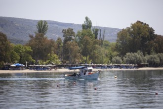 Fishing boat in the Pagasitic Gulf, behind the beach of Kala Nera, Pelion or Pelion Peninsula,