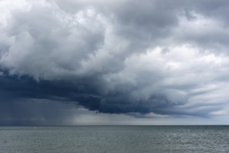 Thick, dark rain clouds gather over the Baltic Sea, Prerow, Mecklenburg-Vorpommern, Germany