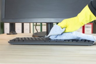 Office cleaning: Close-up of the cleaning of an office desk
