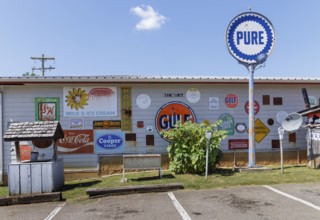 Antique metal advertising signs used for decoration on the side of a building near Counce,