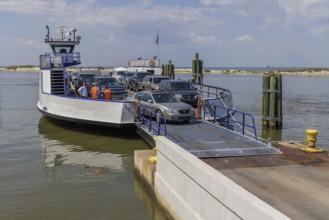 Vehicles driving off the Mobile Bay Ferry at Dauphin Island, Alabama