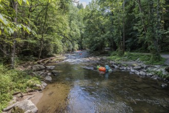 Visitors tubing down Deep Creek in the Smoky Mountains near Bryson City, North Carolina, USA