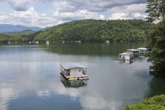 View of a house boats on Fontana Lake as seen from the open air car of the Great Smoky Mountains