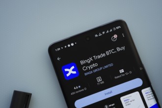 On a blue surface, a smartphone displays the BingX app within the Google Play Store