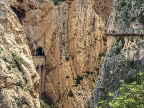 Tourists on the elevated path of the caminito del rey, along a deep gorge, Andalusia, Spain