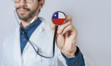 Doctor holding stethoscope with Chile flag. Chile health and care concept, Chile flag on
