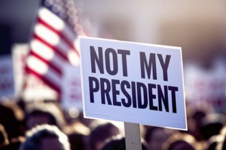 Close up of a protest sign with text 'Not my president with crowd in blurry background. Generative