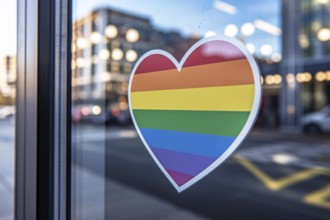 Heart shaped rainbowflag LGBT sticker in shopping window in support of pride month. Generative AI,