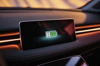 Electric car dashboard showing half full battery charge in close-up display. Generative Ai, AI