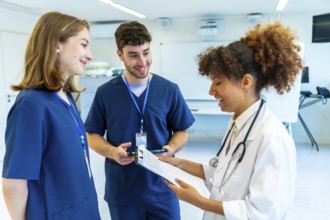 Doctors and nurses collaborating, analyzing medical records and discussing patient treatment in a