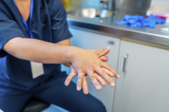Doctor carefully rubbing and washing hands to prevent spread of germs and bacteria in hospital