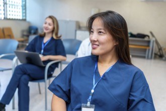 Young asian female nurse smiling during medical training in hospital conference room, healthcare