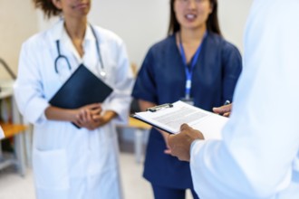 Doctors and nurses are meeting together, sharing expertise and collaborating on patient care,